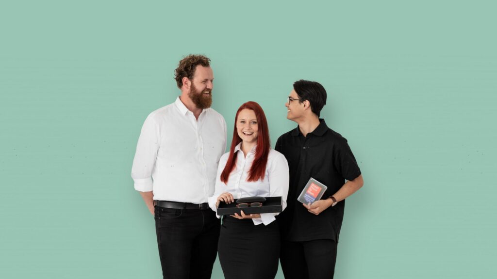 "Company photo of Specsavers with three people smiling"